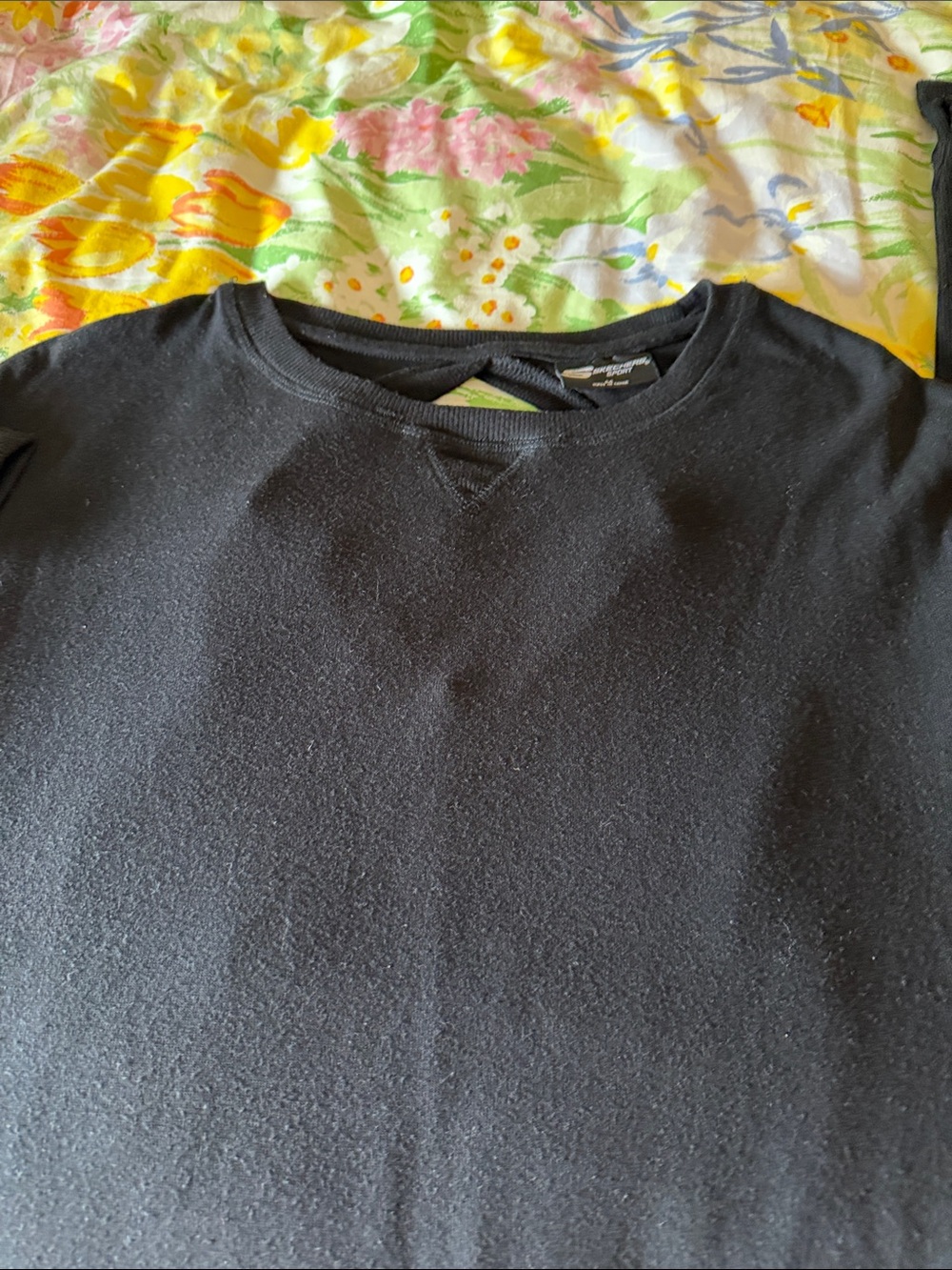 This is a sketches sport black sweater open V-neck in the back